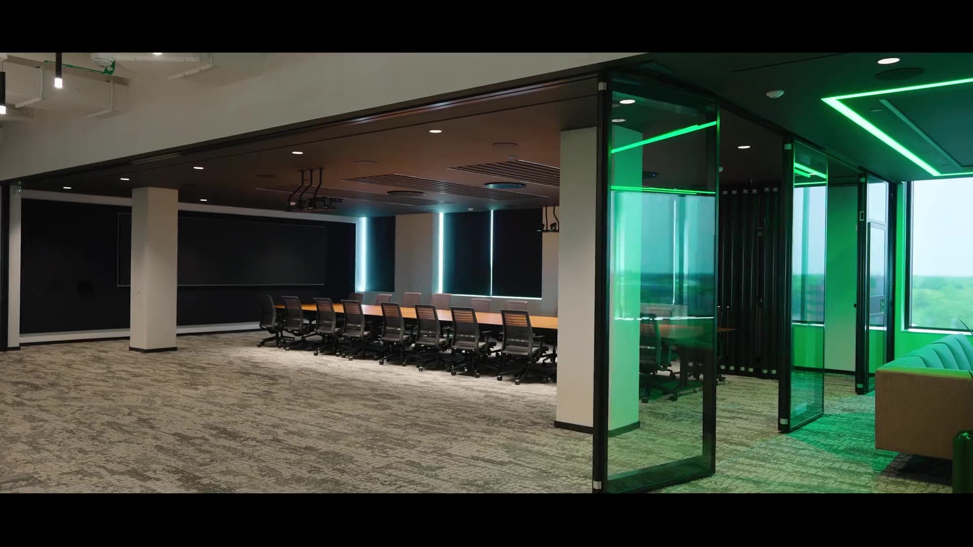 Modernfold Acousti-Clear glass operable wall on ComfortDrive closing across a conference room at the 311 Abbot building